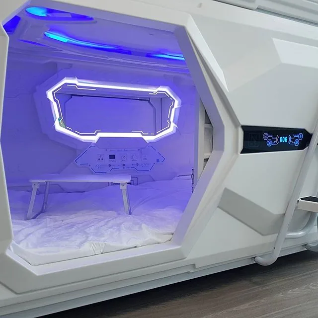 Real capsule bed interior showing lights, control panel and made bed
