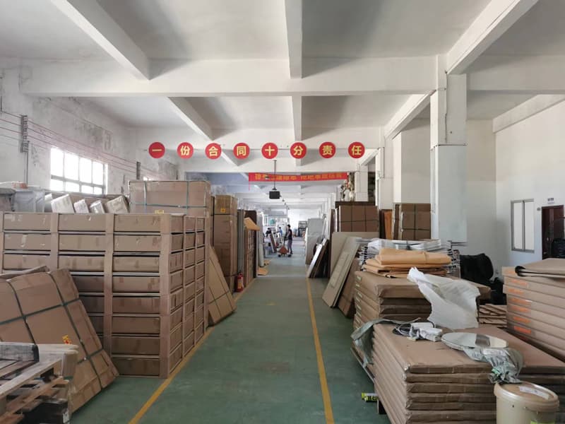Stacks of flat protective materials, cartons and wrapped components in the GEELYE material warehouse